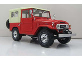 1967 Toyota Landcruiser FJ40 with closed soft top. red/beige